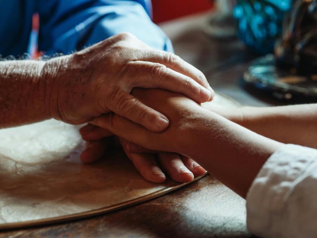 Elderly Man Holding Hands with His Daughter